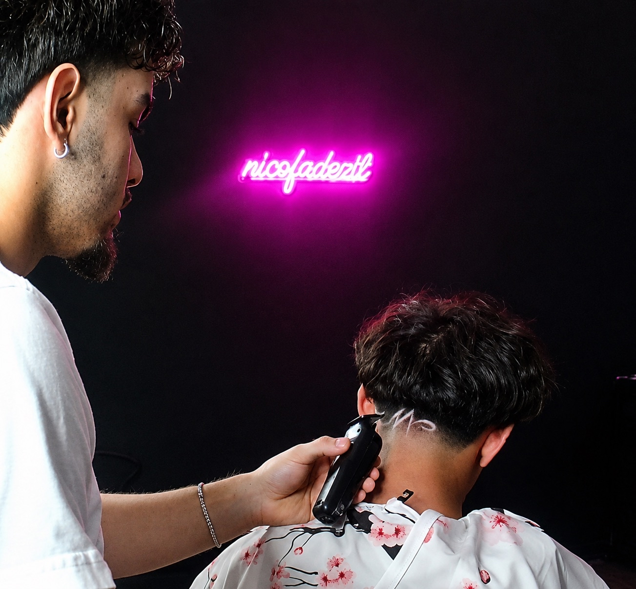 Nico Soto giving a precision fade with a hair design at his Houston shop